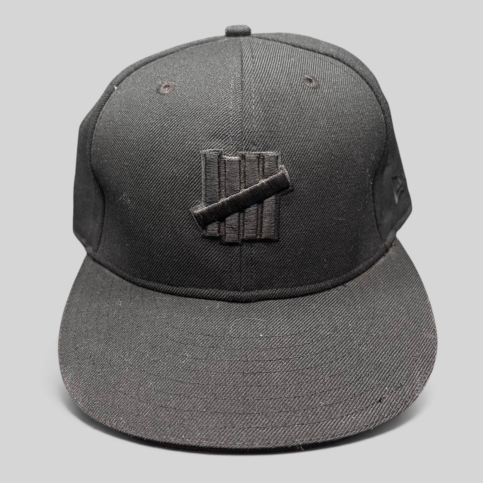 Raree Finds Undefeated 59FIFTY fitted hat in all black with tonal Five Strike logo embroidery on the front panel.