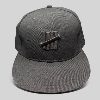 Raree Finds Undefeated 59FIFTY fitted hat in all black with tonal Five Strike logo embroidery on the front panel.