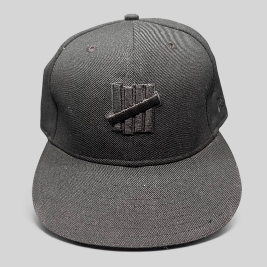 Raree Finds Undefeated 59FIFTY fitted hat in all black with tonal Five Strike logo embroidery on the front panel.