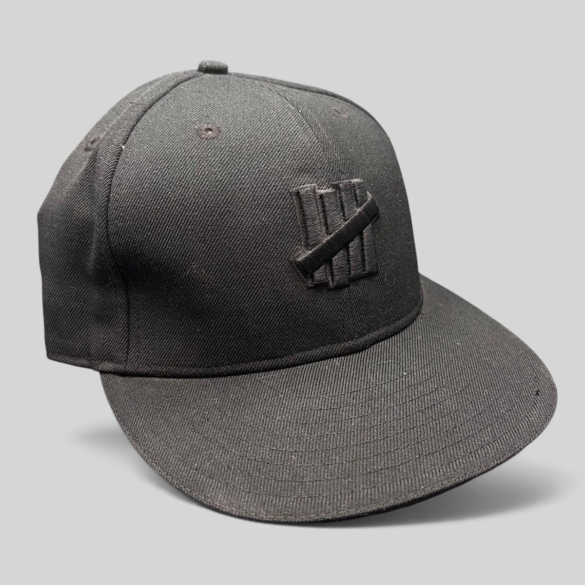 Raree Finds Undefeated 59FIFTY fitted hat in all black with tonal Five Strike logo embroidery on the front panel.
