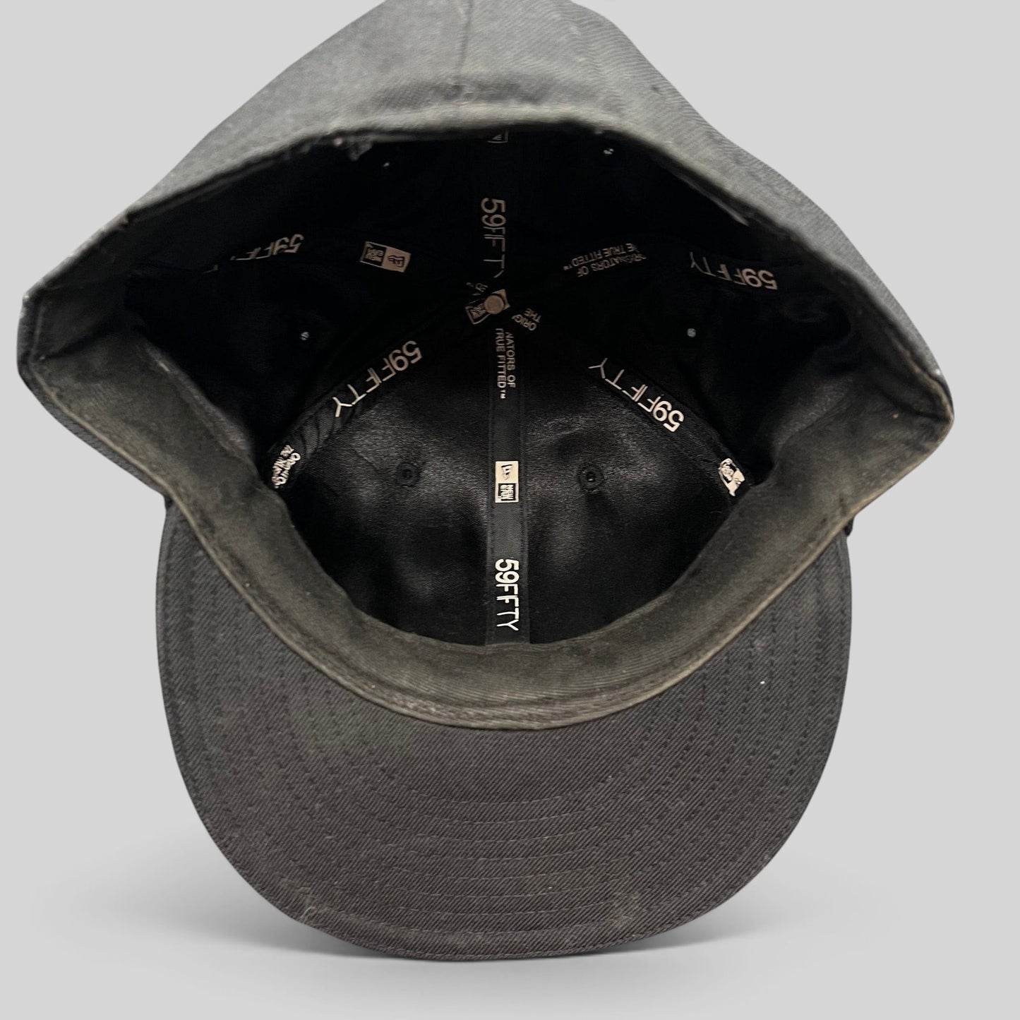 Raree Finds Undefeated New Era 59FIFTY fitted hat interior showing branded taping and structured crown construction