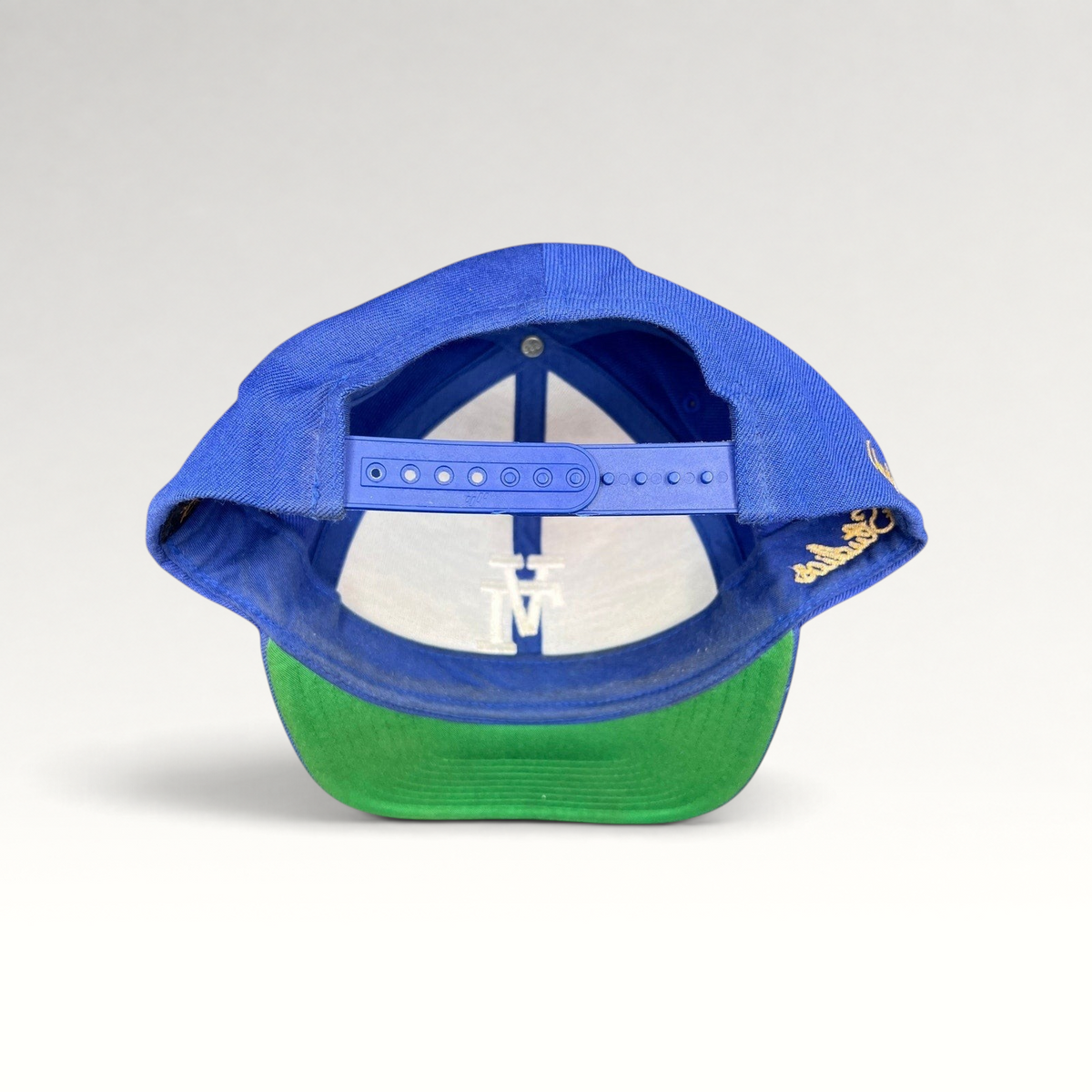 Raree Finds Uniform Studios Los Angeles royal blue snapback hat with green undervisor and adjustable plastic strap