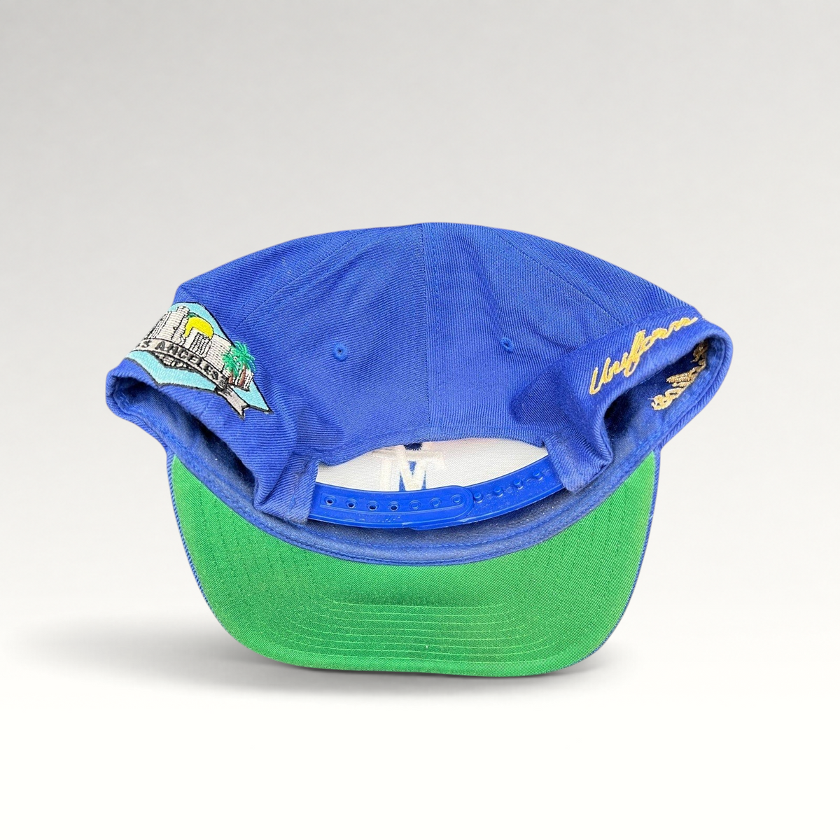 Raree Finds Uniform Studios Los Angeles royal blue snapback hat with green undervisor and city patch detail