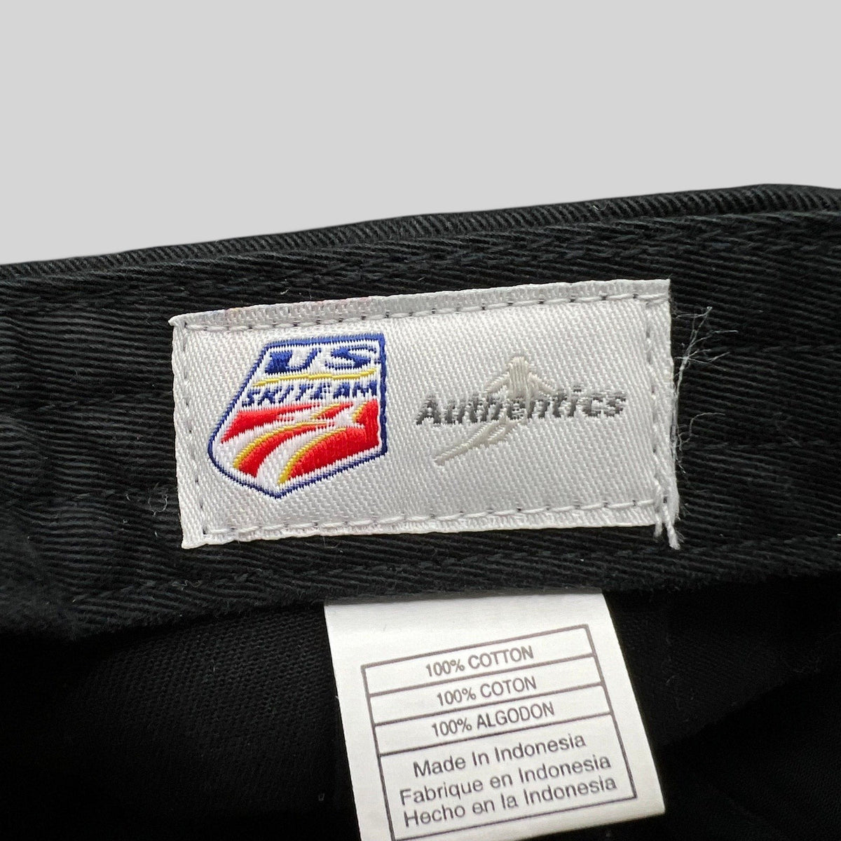 Raree Finds vintage 2006 USA Ski Team hat interior label showing Authentic USA branding and cotton fabric tag