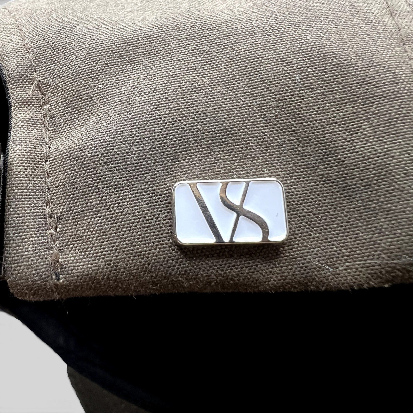 Raree Finds Varsity Headwear olive brown strapback hat featuring a polished metal logo detail on the side panel