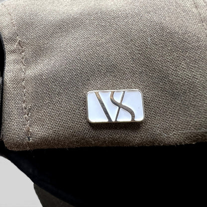 Raree Finds Varsity Headwear olive brown strapback hat featuring a polished metal logo detail on the side panel