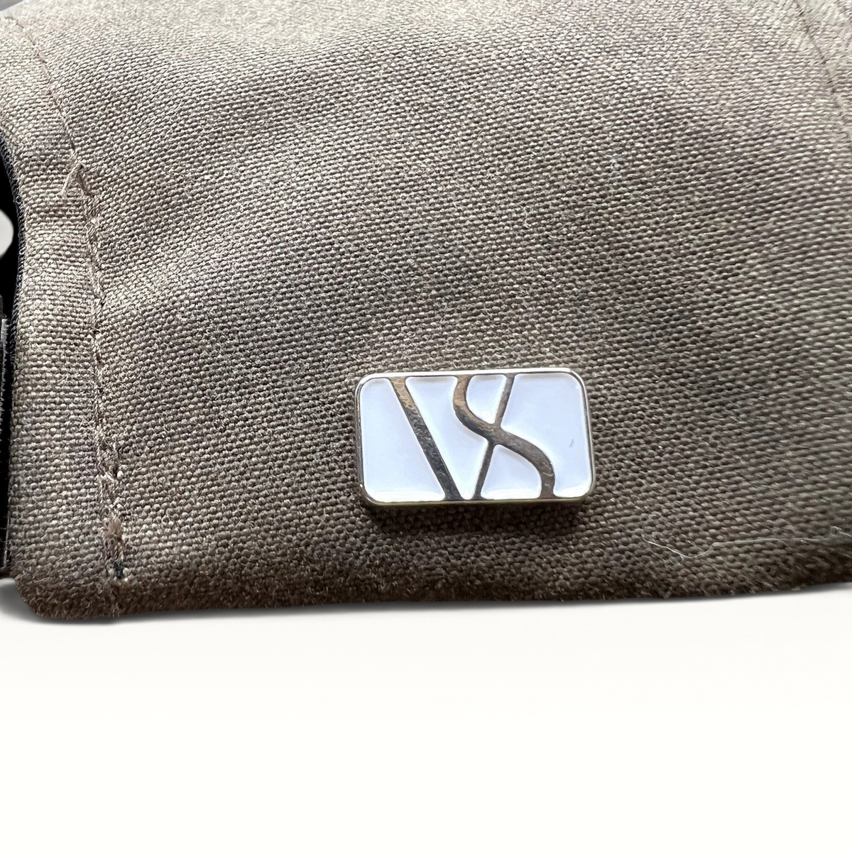 Raree Finds Varsity Headwear olive brown strapback hat featuring a polished metal logo detail on the side panel