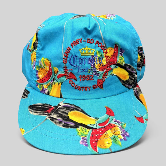 Raree Finds vintage 1992 High Country Shootout golf hat in turquoise with tropical toucan print and Corona branding.
