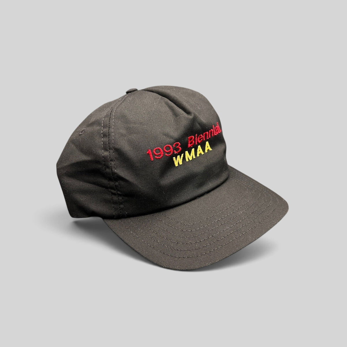 Raree Finds vintage 1993 WMAA Biennial black snapback cap with red and yellow embroidery and a flat bill.