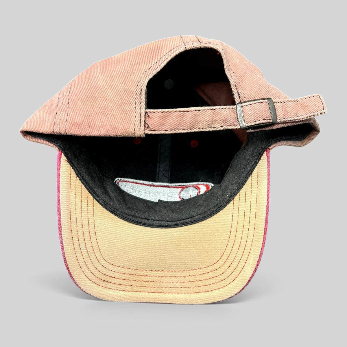 Raree Finds vintage ABC Sports strapback hat with a tan crown, pink brim, and adjustable metal buckle strap.