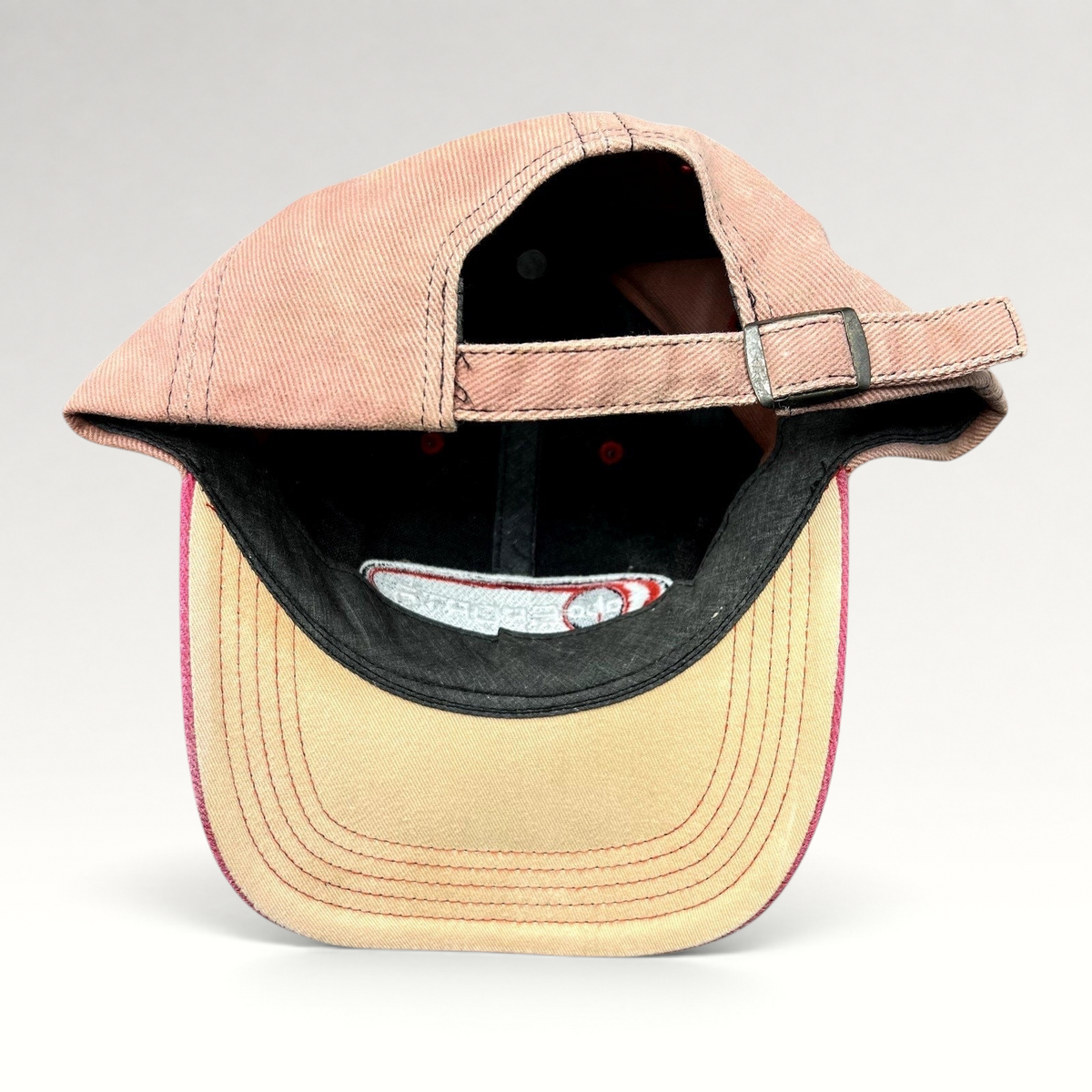 Raree Finds vintage ABC Sports strapback hat with a tan crown, pink brim, and adjustable metal buckle strap.