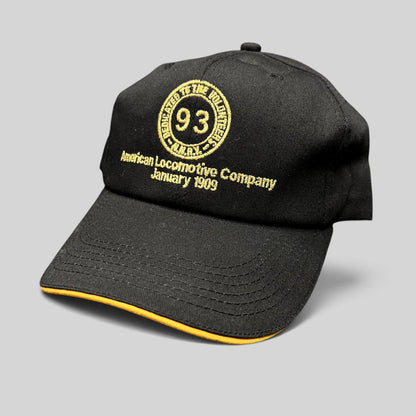 Raree Finds vintage black K-Products strapback hat with gold American Locomotive Company embroidery and brim rope.