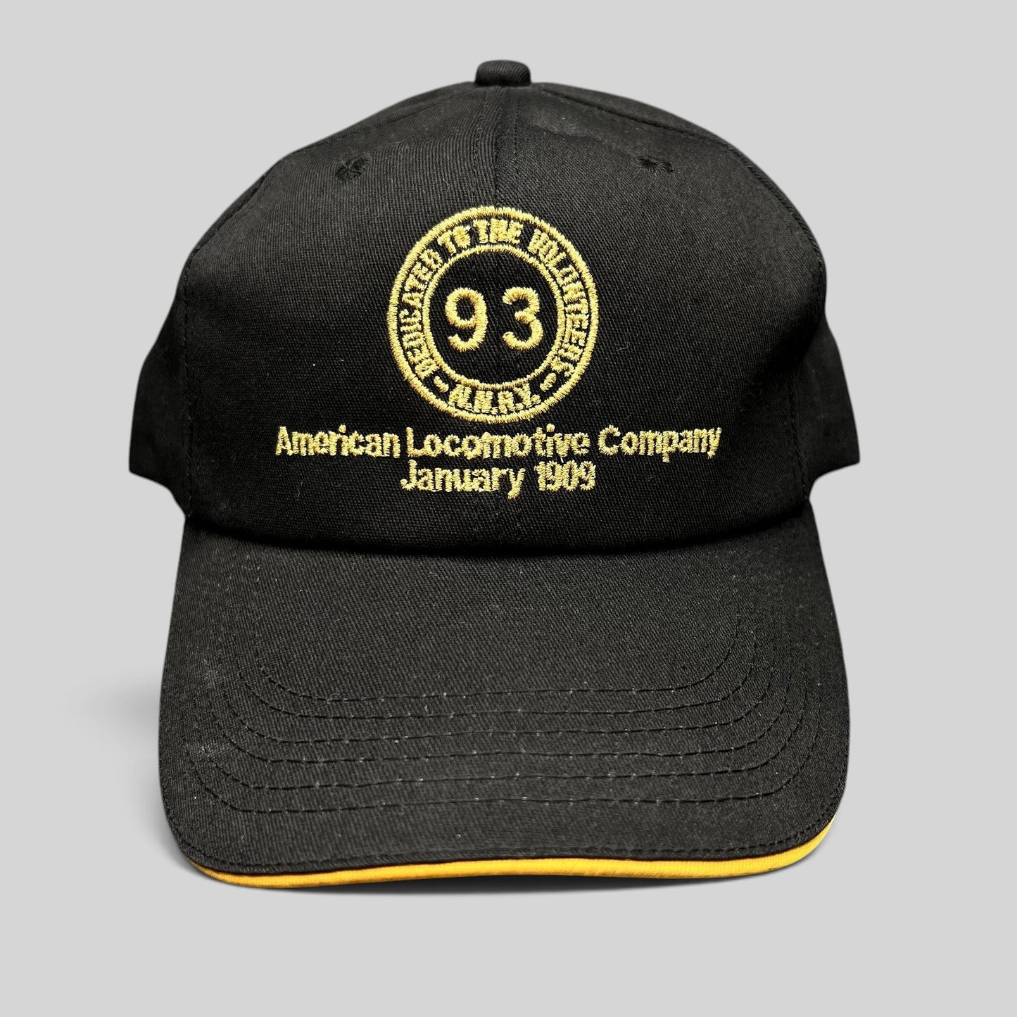 Raree Finds vintage black K-Products strapback hat with gold American Locomotive Company embroidery and rope detail.