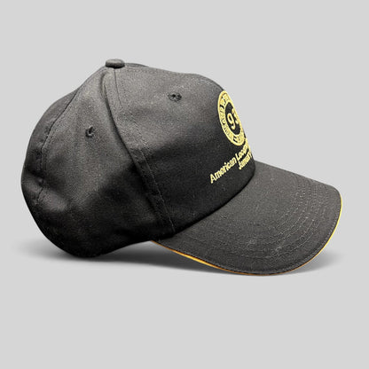 Raree Finds vintage black K-Products strapback hat with gold American Locomotive Company embroidery and brim rope.