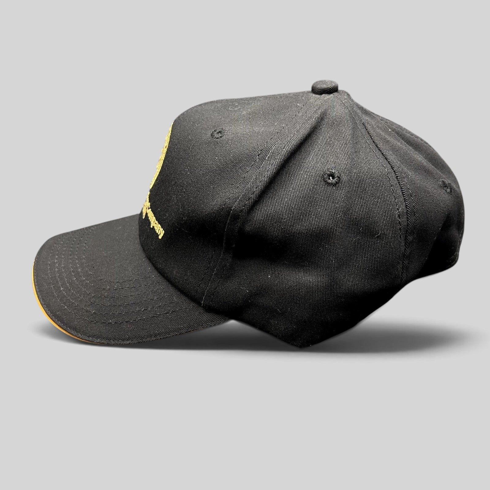 Raree Finds vintage black K-Products strapback hat with gold American Locomotive Company embroidery and brim rope.