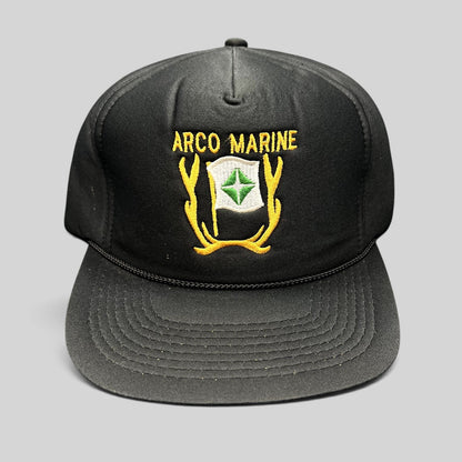 Raree Finds vintage black ARCO Marine snapback hat with yellow and green embroidered logo and black rope brim detail.