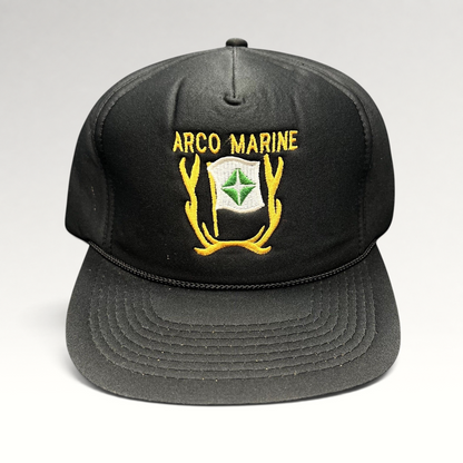 Raree Finds vintage black ARCO Marine snapback hat with yellow and green embroidered logo and black rope brim detail.