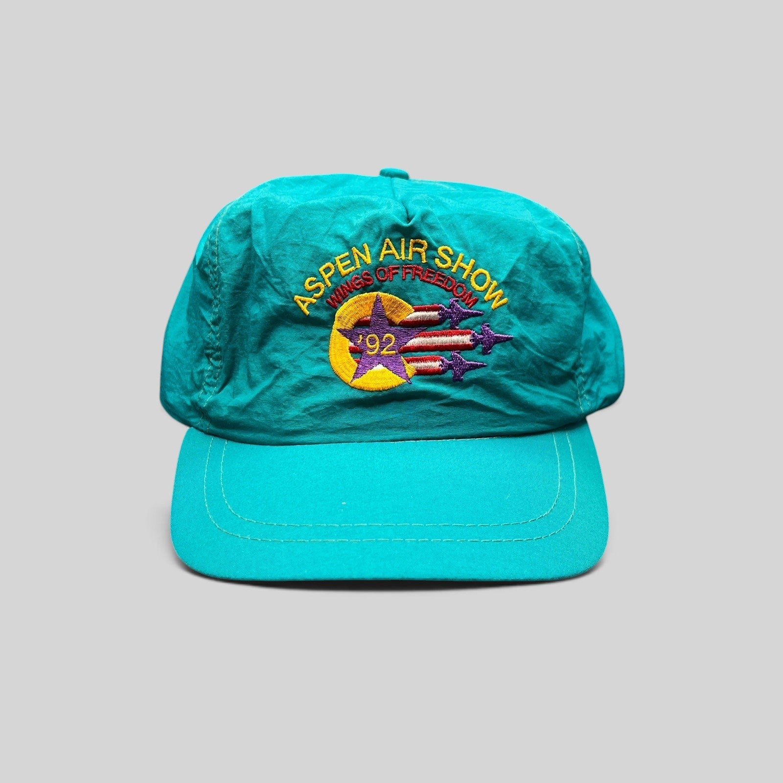 Raree Finds vintage 1992 Aspen Air Show teal nylon snapback hat with Wings of Freedom embroidered graphic