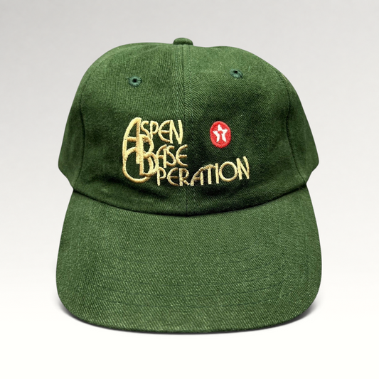 Raree Finds vintage dark green Aspen Base Operation strapback hat with embroidered gold script and red cross emblem.