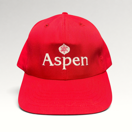 Raree Finds vintage red Aspen Snowmass snapback hat with white embroidered logo and green undervisor, made in USA.