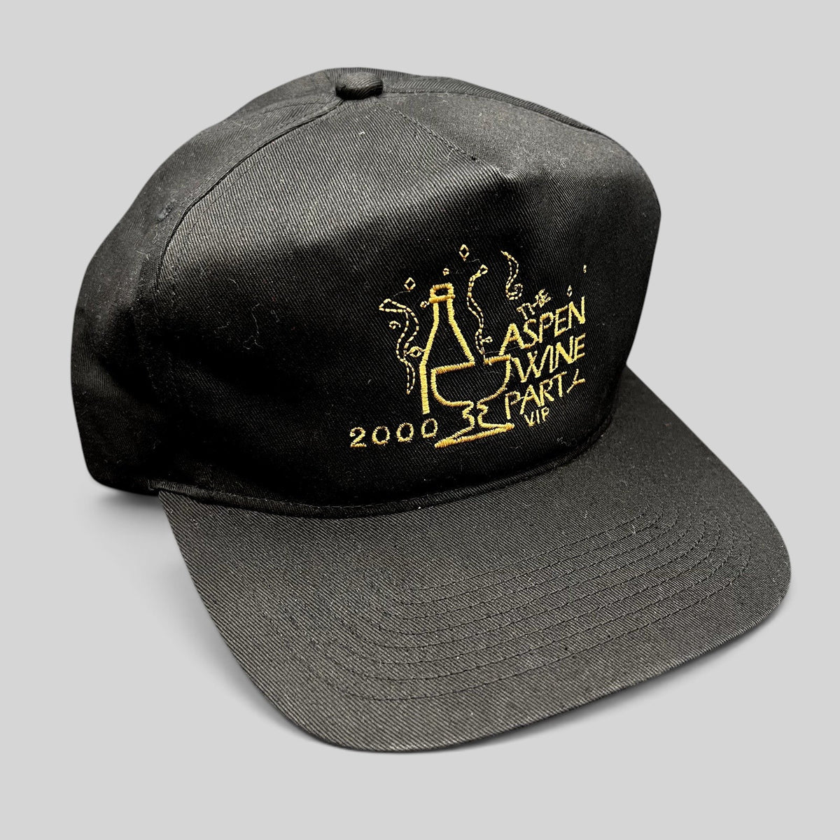 Raree Finds vintage 2000 Aspen Wine Party VIP black strapback hat with gold embroidered champagne bottle graphic