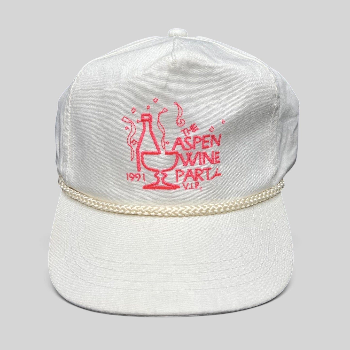 Raree Finds vintage 1991 Aspen Wine Party white strapback hat with pink graphic and decorative rope brim detail