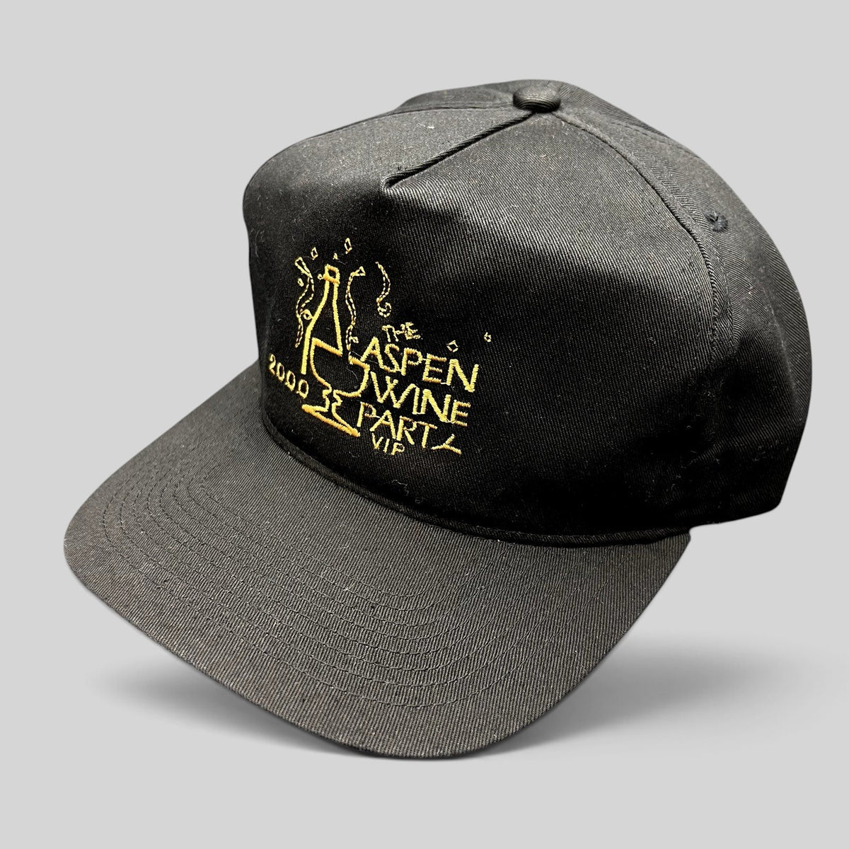 Raree Finds vintage 2000 Aspen Wine Party VIP black strapback hat with gold champagne bottle embroidery
