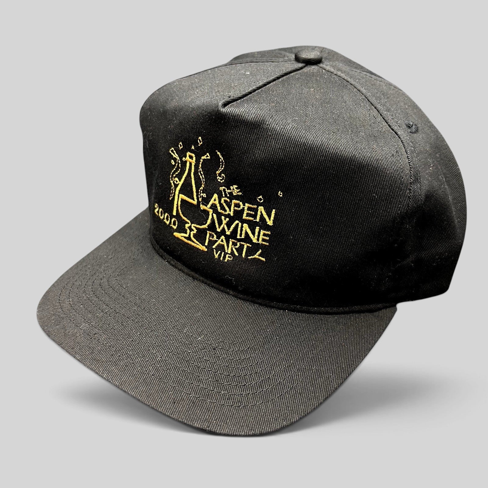 Raree Finds vintage 2000 Aspen Wine Party VIP black strapback hat with gold champagne bottle embroidery