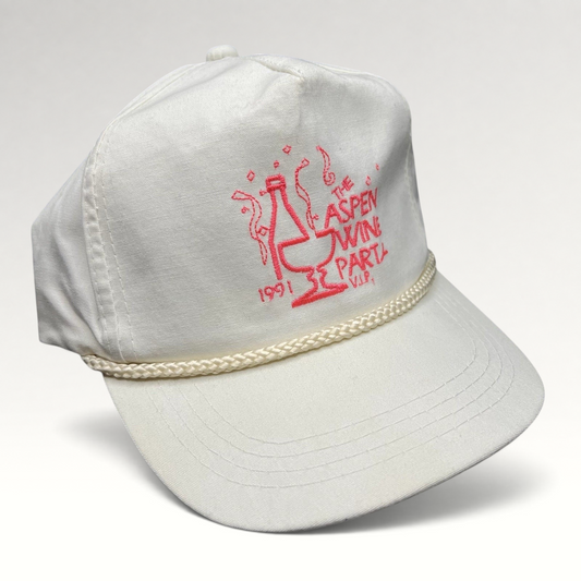Raree Finds vintage 1991 white Yupoong strapback hat with pink Aspen Wine Party graphic and decorative brim rope