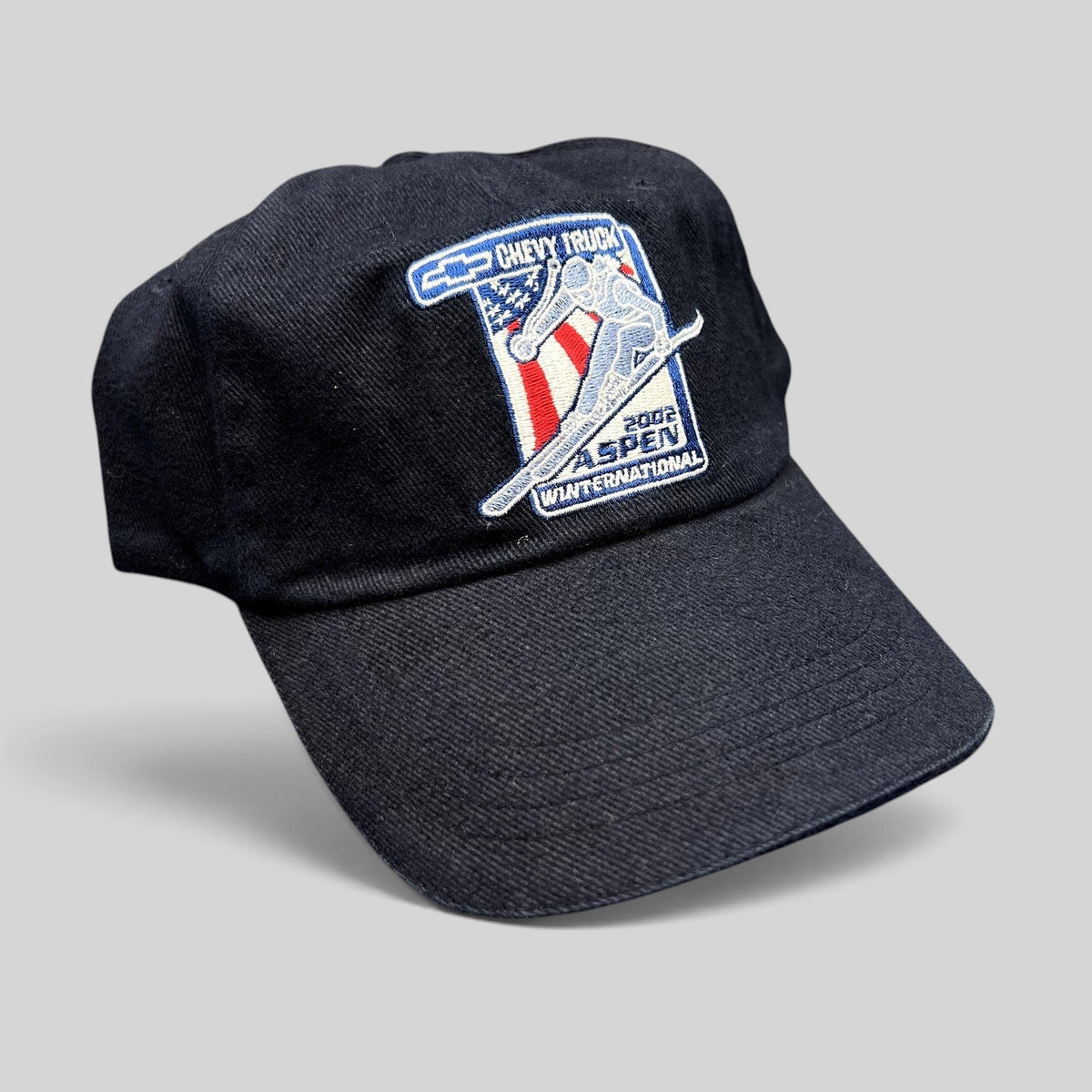 Raree Finds vintage 2002 Aspen Winternational strapback hat in navy with embroidered Chevy Truck skier patch