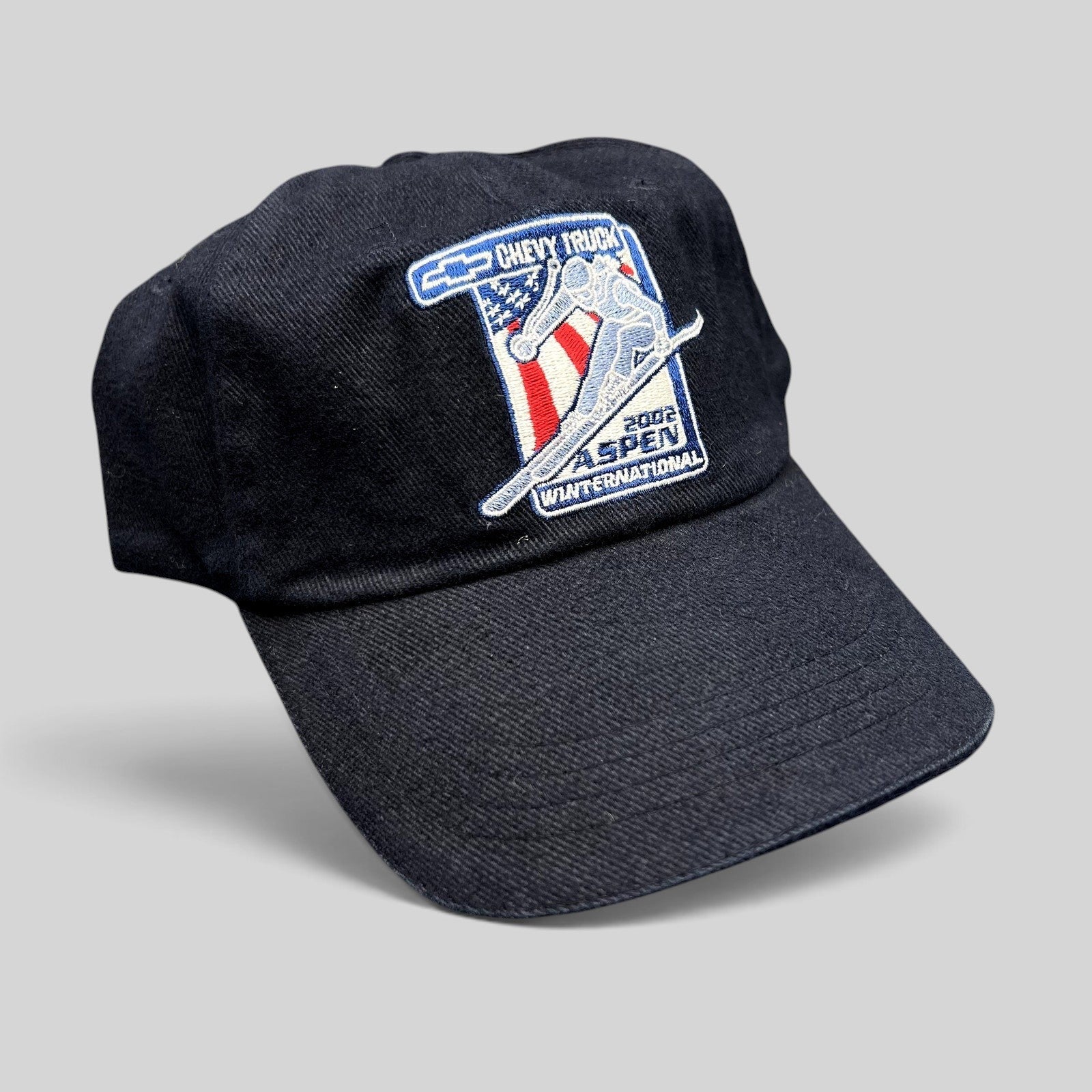 Raree Finds vintage 2002 Aspen Winternational strapback hat in navy with embroidered Chevy Truck skier patch