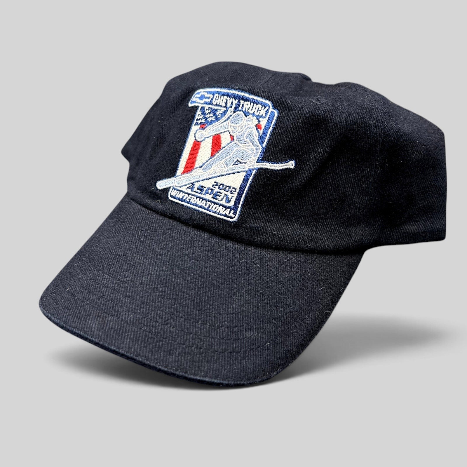 Raree Finds vintage 2002 Aspen Winternational navy strapback hat with embroidered Chevy Truck freestyle skier patch