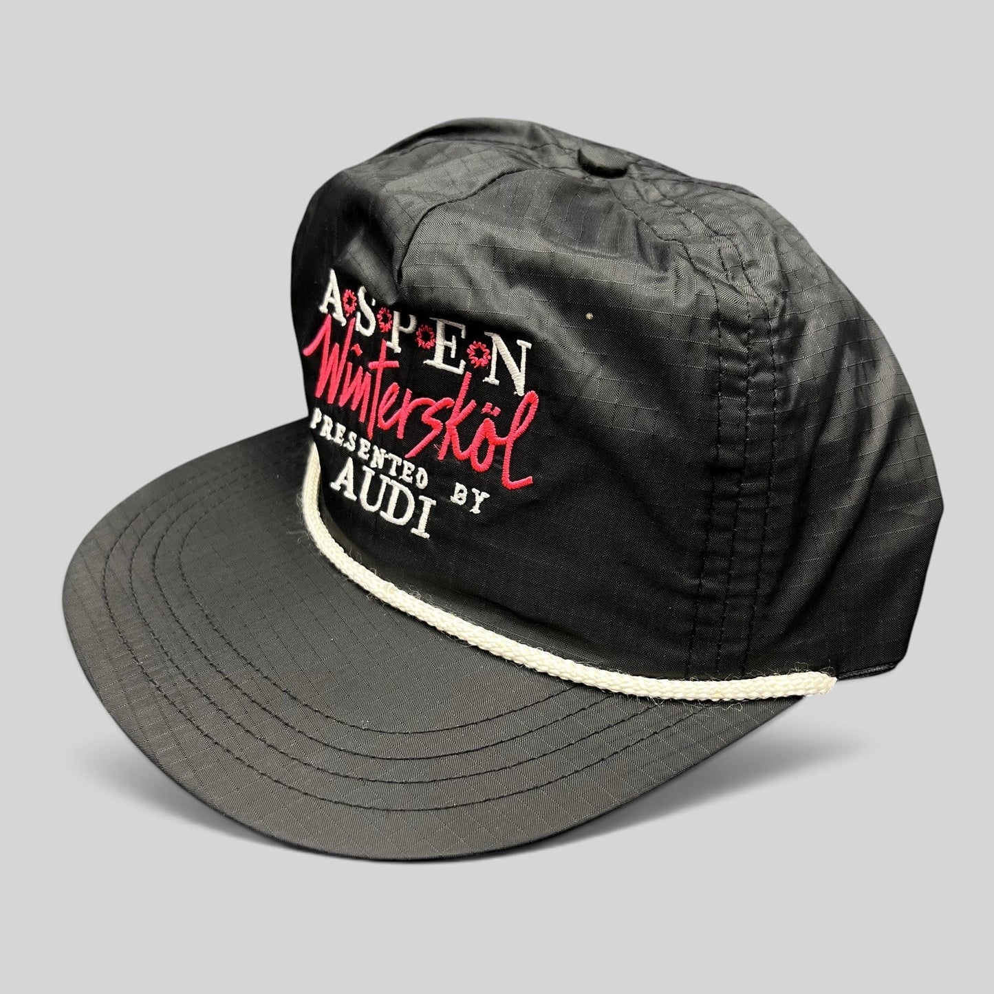 Raree Finds vintage black ripstop nylon Aspen Wintersköl Audi snapback hat with white rope detail and pink embroidery.