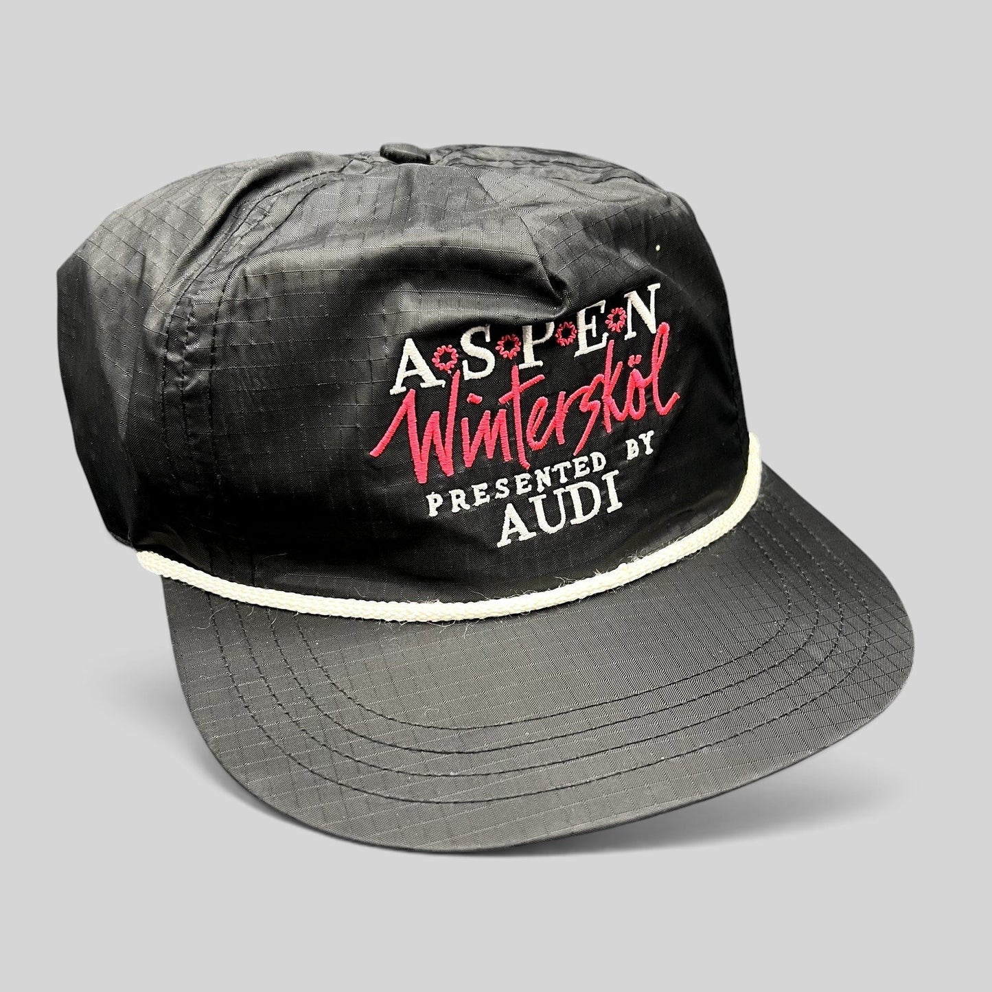 Raree Finds vintage black ripstop nylon snapback hat with white rope and Aspen Wintersköl Audi embroidery.