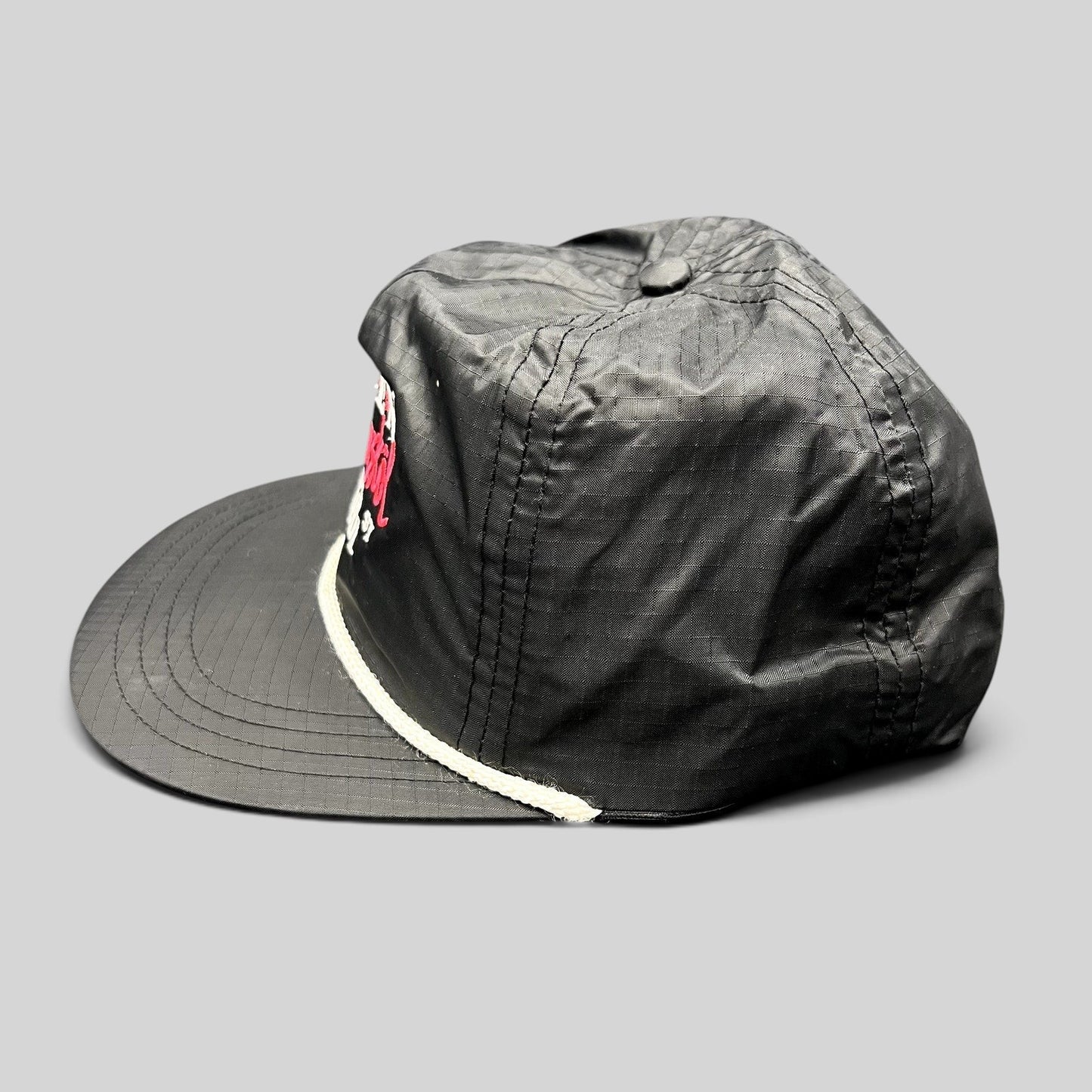 Raree Finds vintage black ripstop nylon snapback hat with white rope detail and Aspen Wintersköl Audi embroidery.