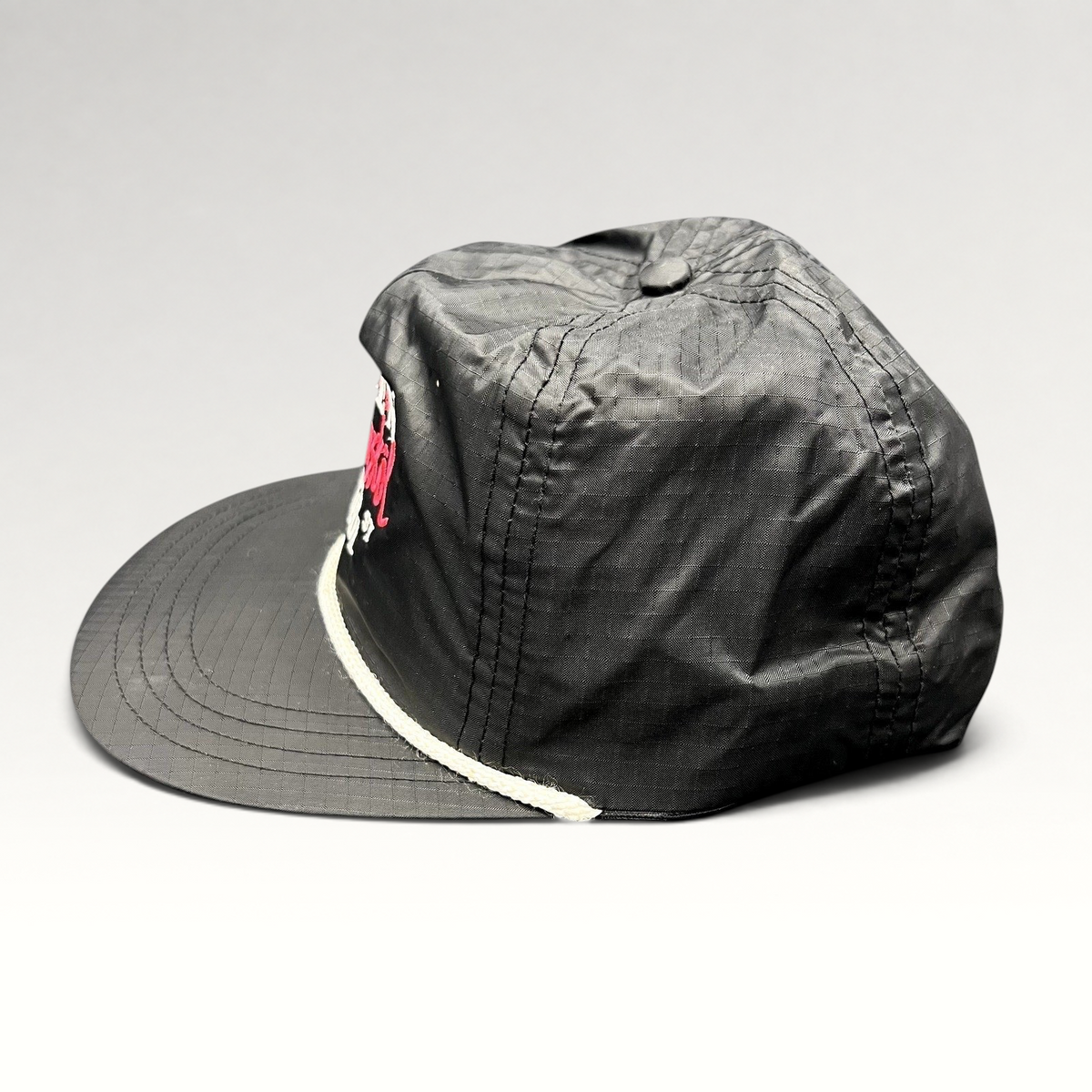 Raree Finds vintage black ripstop nylon snapback hat with white rope detail and Aspen Wintersköl Audi embroidery.