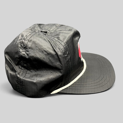 Raree Finds vintage black ripstop nylon snapback hat with white rope detail and Aspen Wintersköl Audi embroidery.