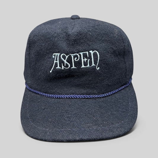 Raree Finds vintage navy wool snapback hat with Aspen script embroidery and decorative rope trim on the brim.