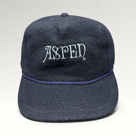 Raree Finds vintage navy wool snapback hat with Aspen script embroidery and decorative rope trim on the brim.