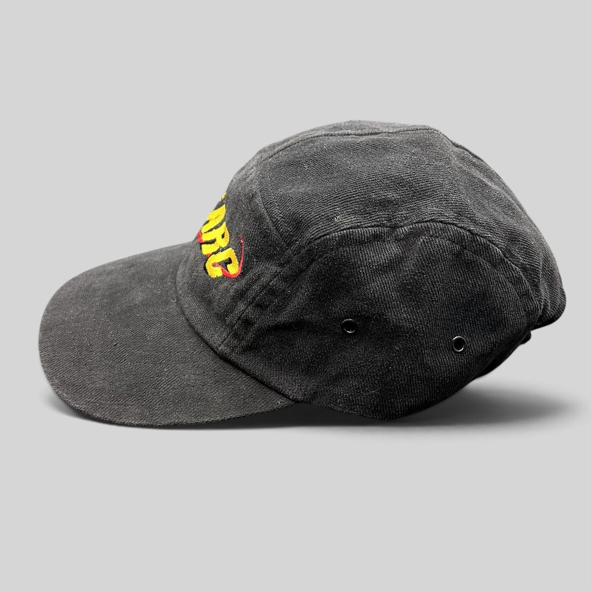Raree Finds vintage black cotton Atomic ARC strapback hat with yellow and red embroidered logo, side profile view.