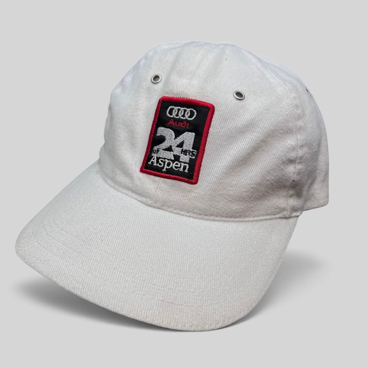 Raree Finds vintage white Audi 24 HRS of Aspen cotton strapback hat with embroidered motorsport event patch