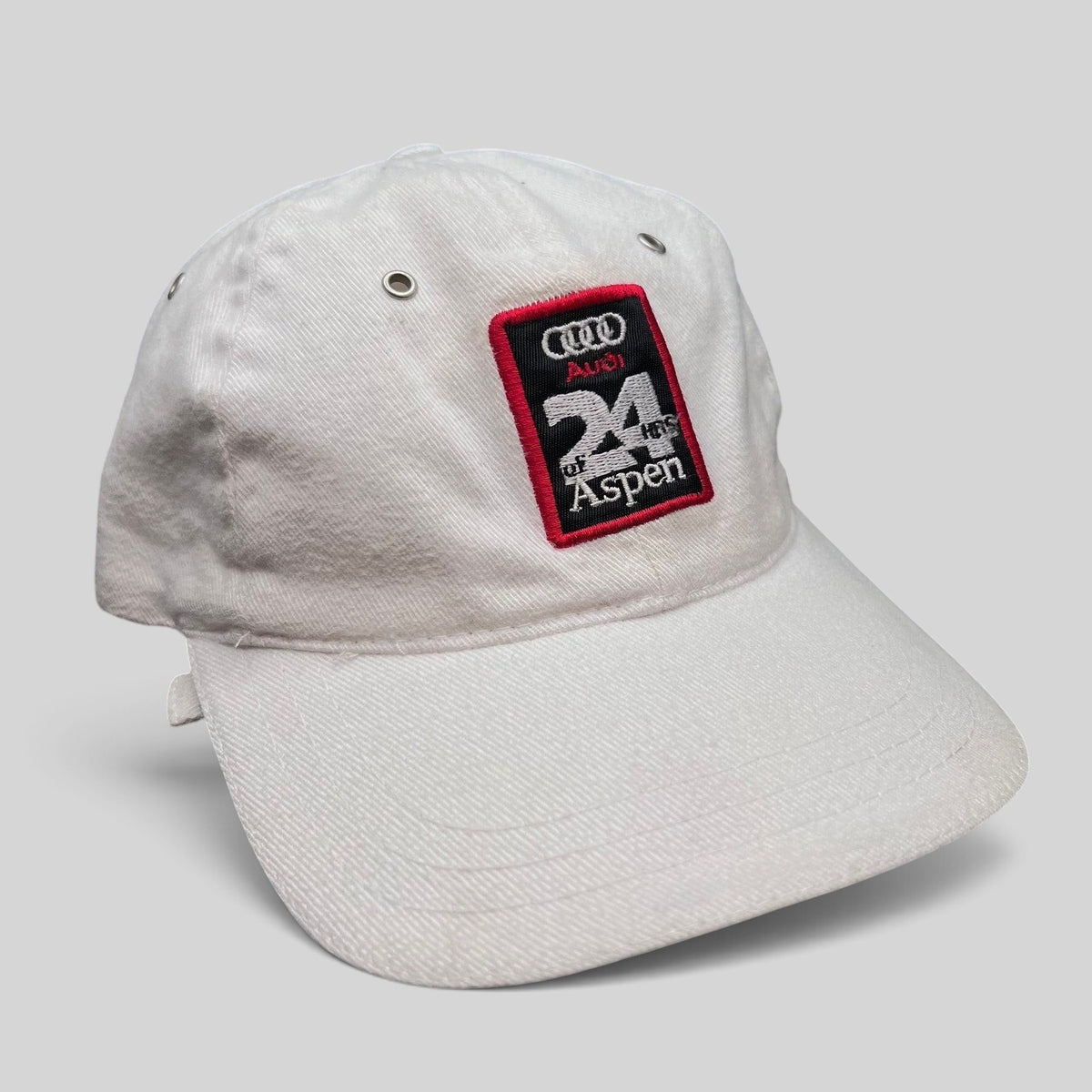 Raree Finds vintage white Audi 24 HRS of Aspen cotton strapback hat with a motorsport embroidered patch.