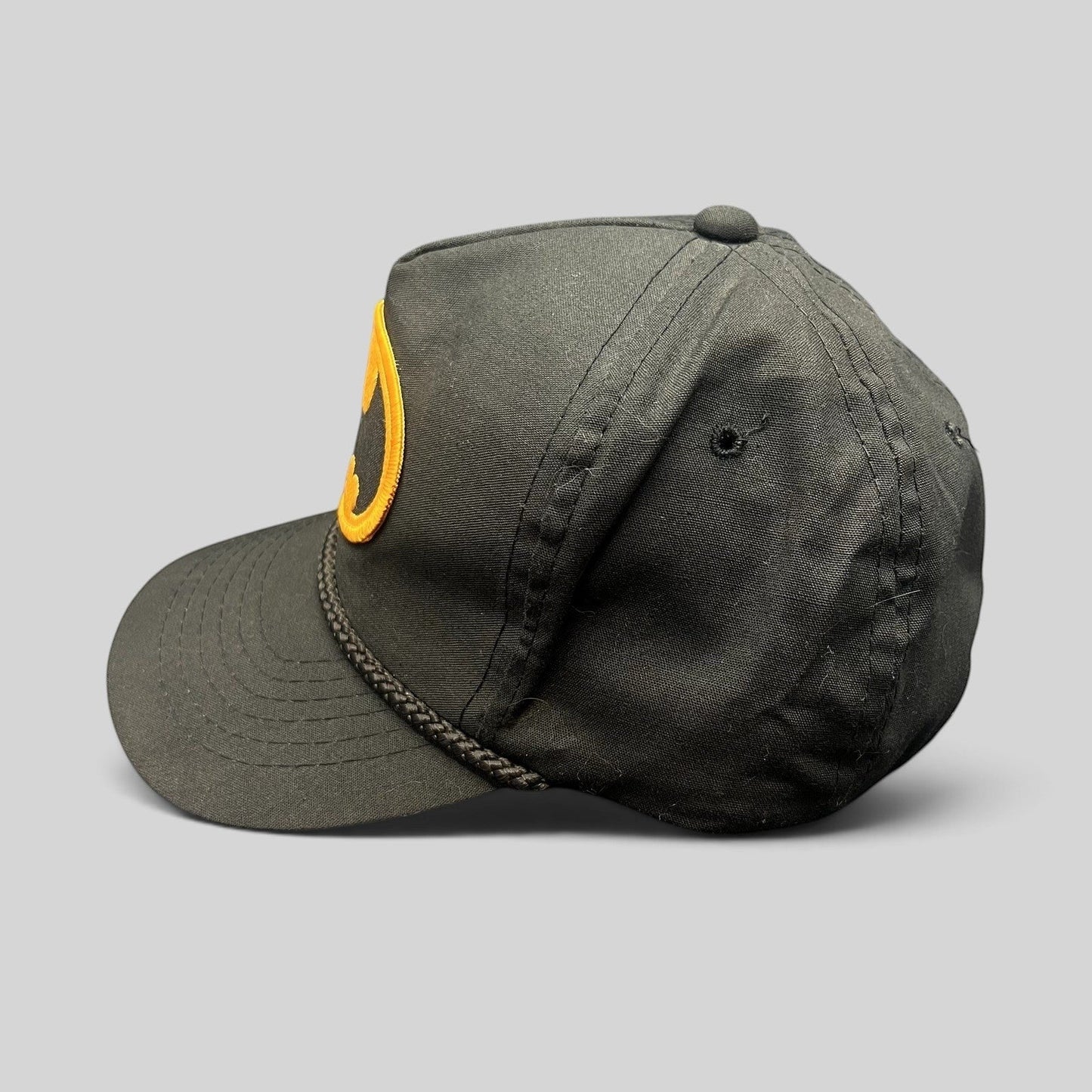 Raree Finds vintage black Batman snapback hat with yellow embroidered logo and braided rope detail on the brim