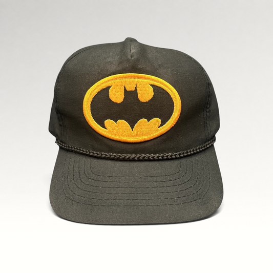 Raree Finds vintage black Batman snapback hat with yellow embroidered bat logo and braided rope detail