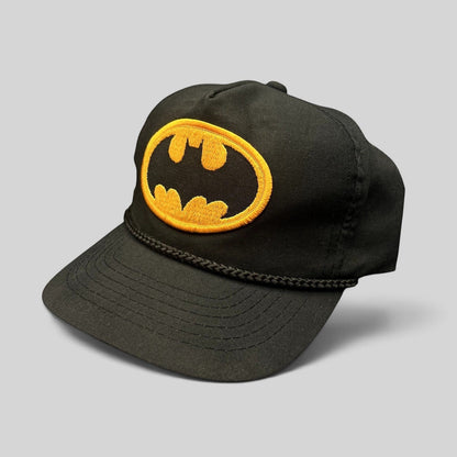 Raree Finds vintage black Batman snapback hat with yellow embroidered logo patch and braided rope detail