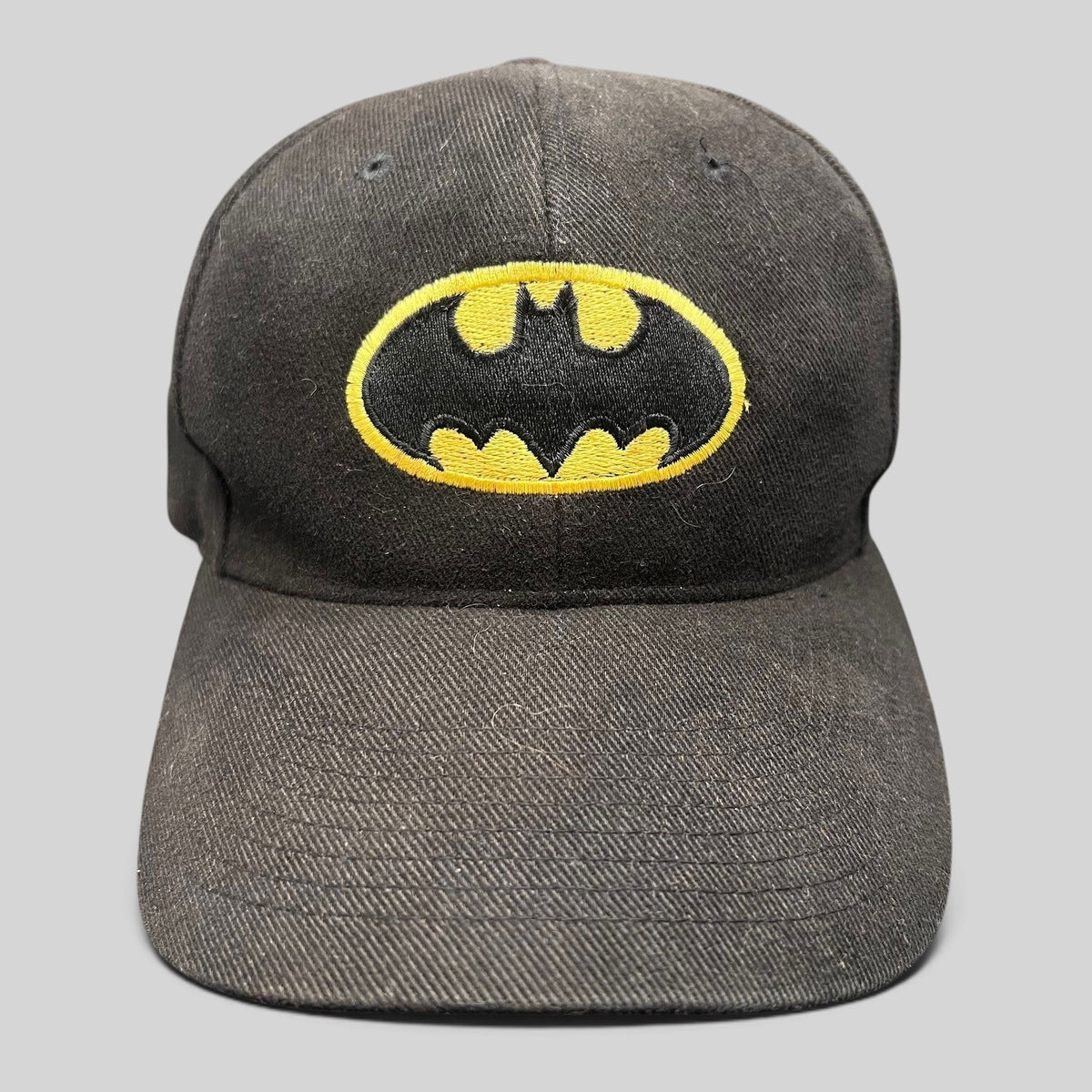 Raree Finds vintage black Batman strapback hat with embroidered yellow and black comic book logo on the front crown