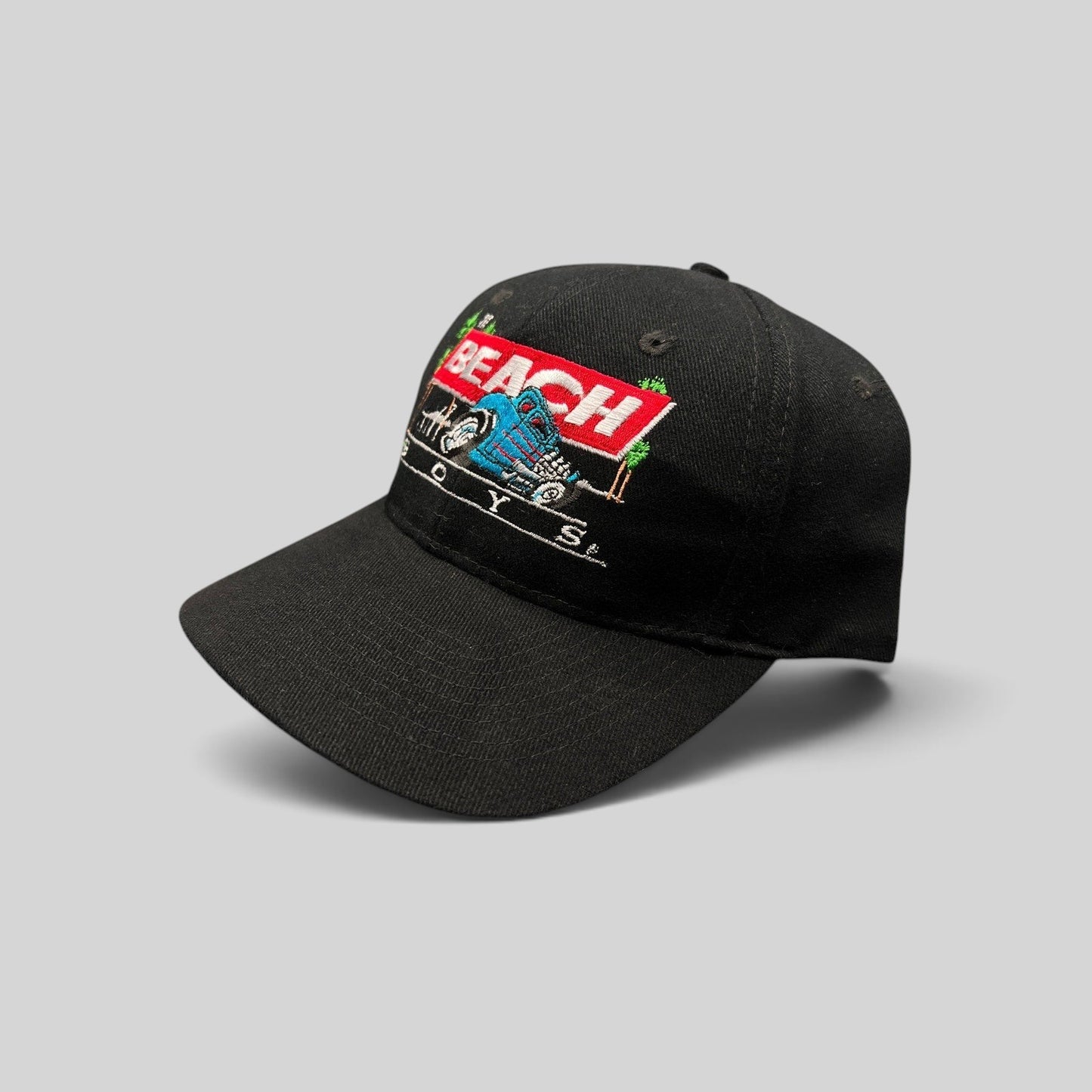 Raree Finds vintage 1990s black Beach Boys snapback hat featuring a colorful Little Deuce Coupe hot rod embroidery.