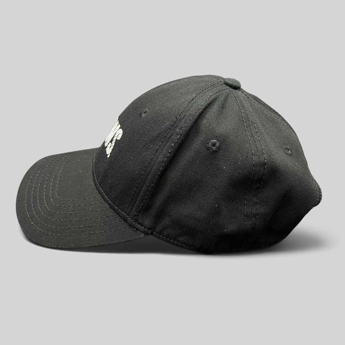 Raree Finds vintage black OTTO Cap snapback hat featuring an embroidered E! News logo, side profile view.