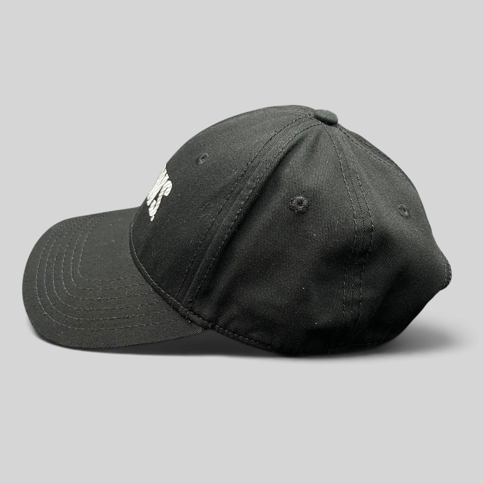 Raree Finds vintage black OTTO Cap snapback hat featuring an embroidered E! News logo, side profile view.