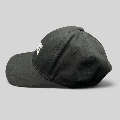 Raree Finds vintage black OTTO Cap snapback hat featuring an embroidered E! News logo, side profile view.